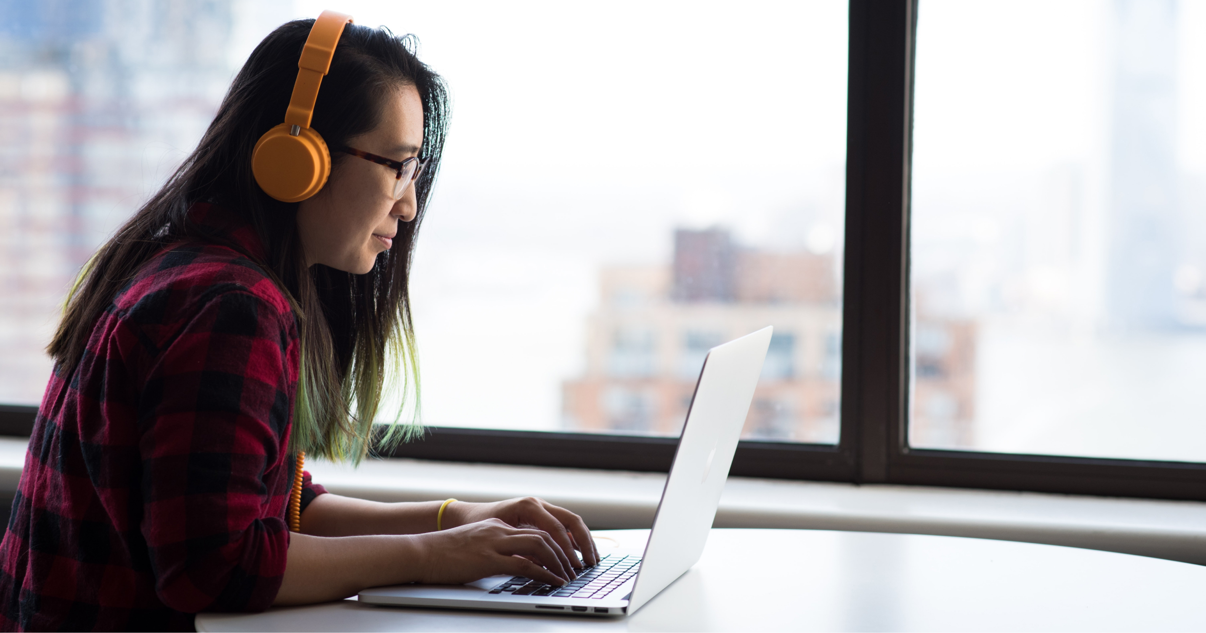 Woman happily working at computer